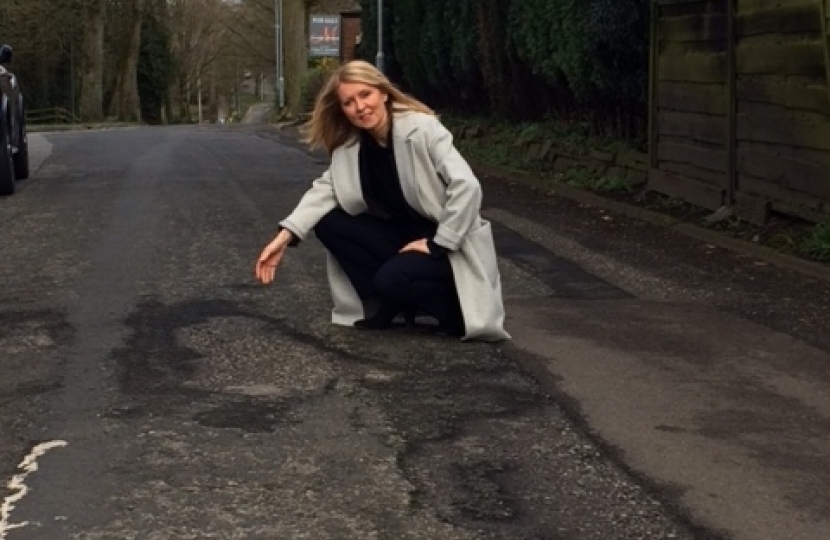 Esther with the potholes in Hall Road, Handforth