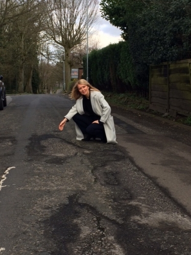 Esther with the potholes in Hall Road, Handforth