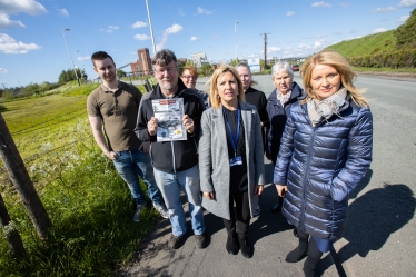 Esther McVey, Cllr Helen Treeby and local residents outside the site of an incinerator currently being built in Rudheath